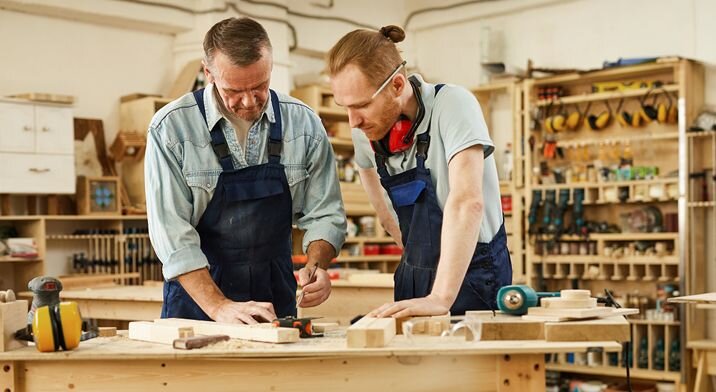 Two men collaborate in their workshop