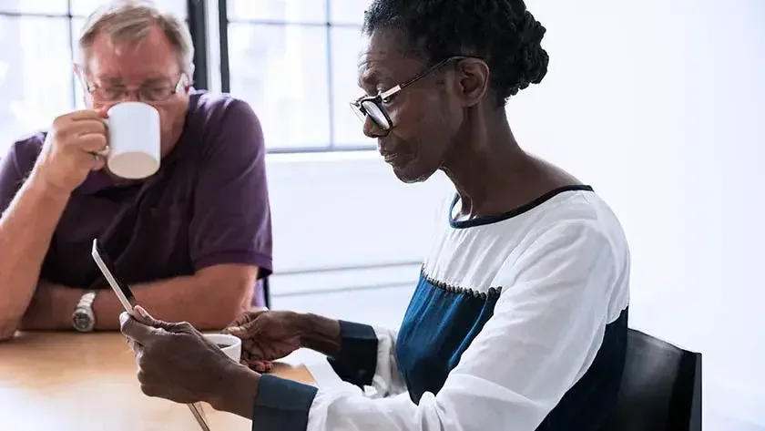 A retired couple checking on their tablet on creating their will without the help of an attorney.