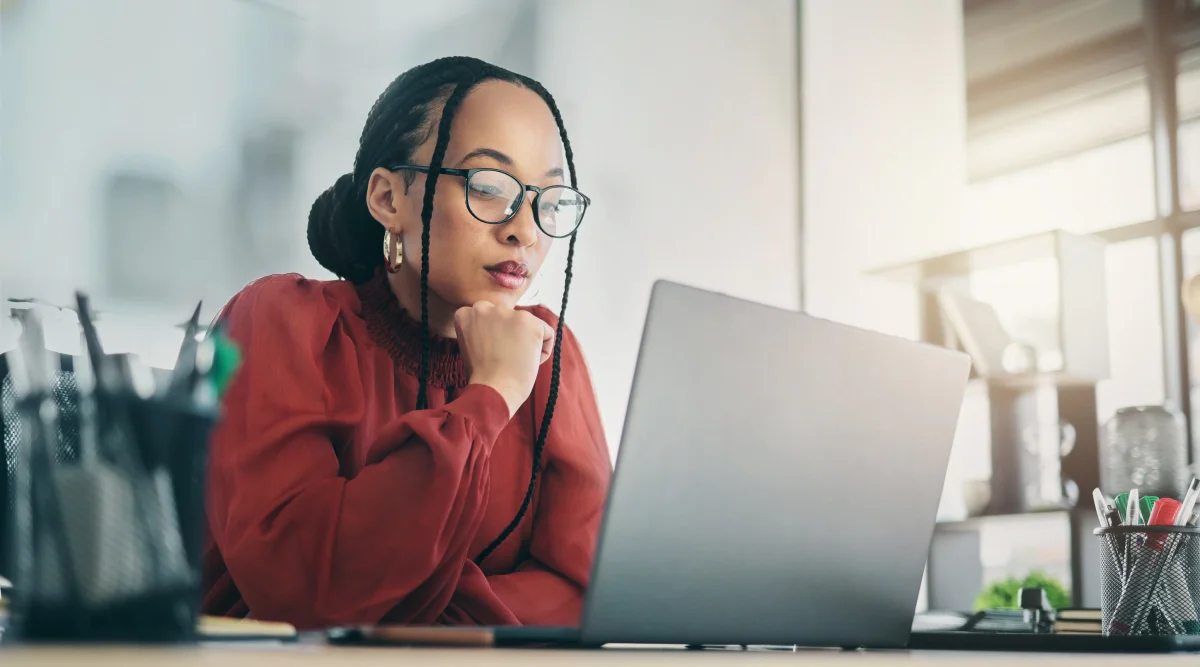 Woman focused on a laptop screen in a quiet office