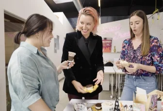 three woman speak and eat ice cream together