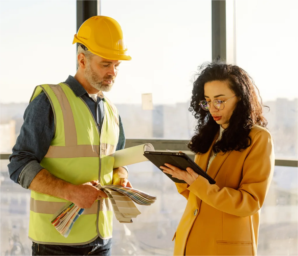 Man and woman discuss a construction project 