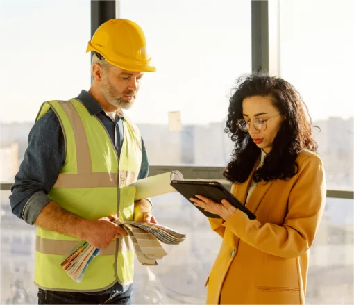 Man and woman discuss a construction project 