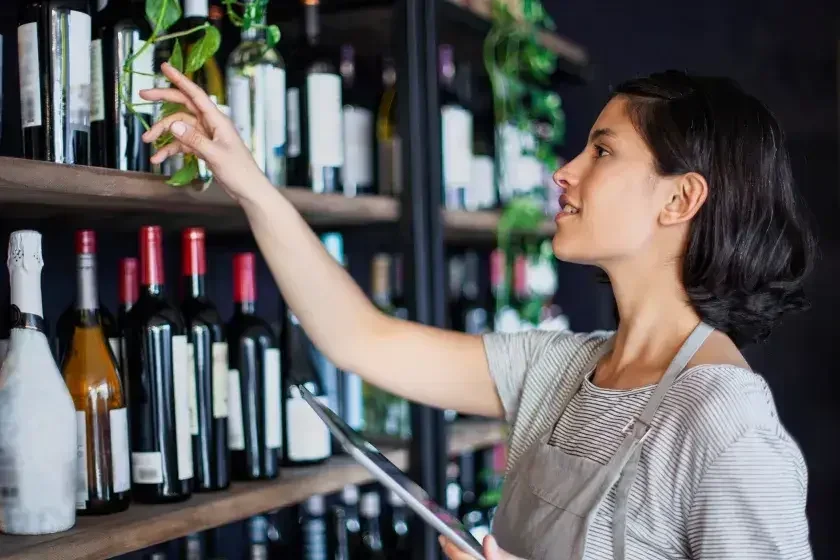 A business owner checks inventory in her shop. Not all businesses need to file a BOI report, but most do.