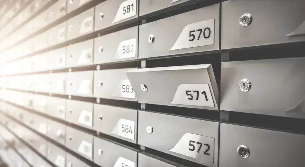 A row of small numbered mailboxes. Rental prices of U.S. post office boxes vary widely.