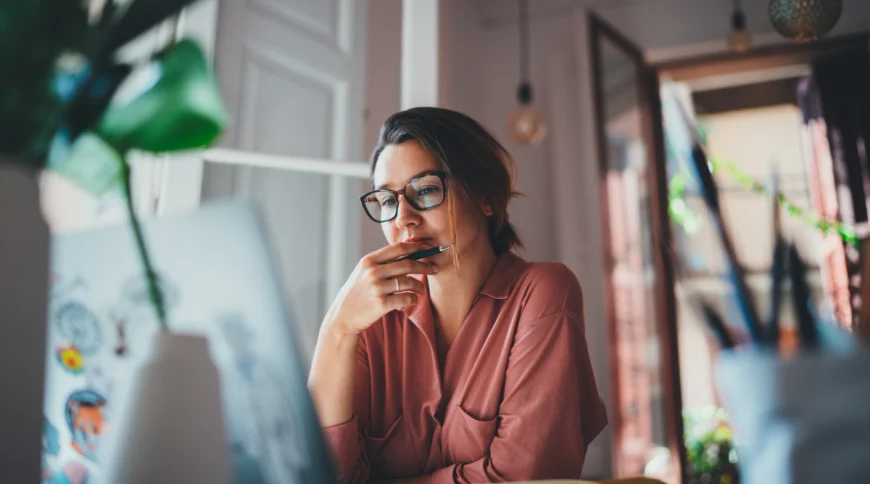 A woman seated in front of her computer looks up owners of an LLC.