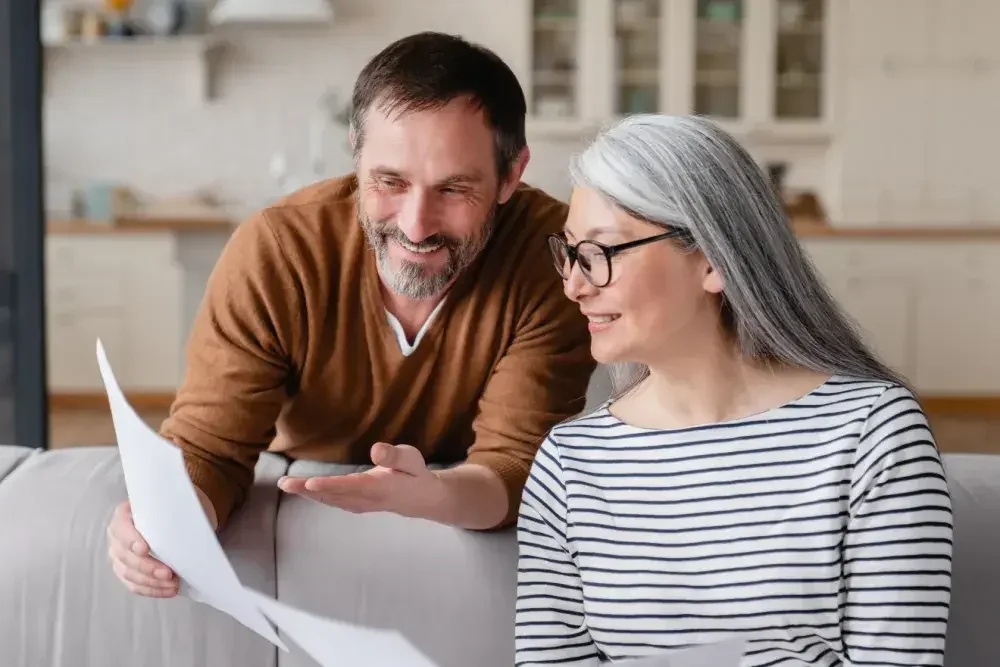 There are four major types of trusts: Here, a man and a woman read documents related to their trust.