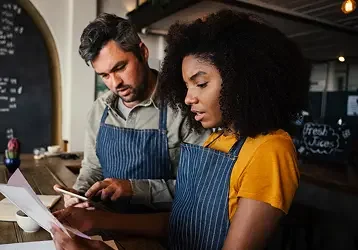 A man and women collaborate in their workshop