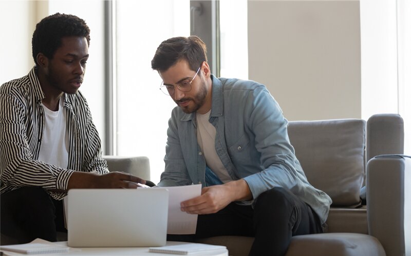 An image of two men discussing an agreement in the office.