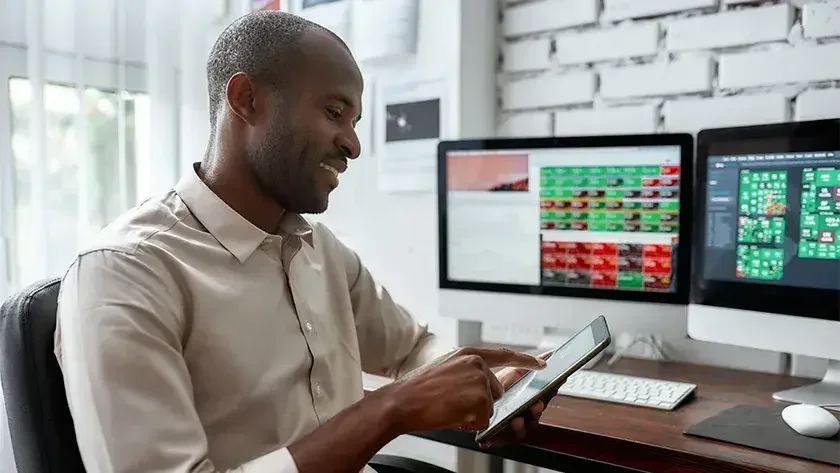 A business owner checks stock prices on his iPad. If your goal is to raise capital through institutional investors, the corporate structure will likely make more sense.
