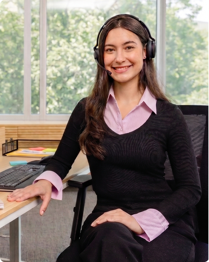A woman seated at her desk