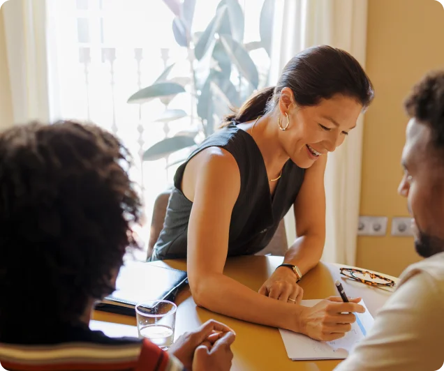 A woman on a modern office helping a couple draft their prenup