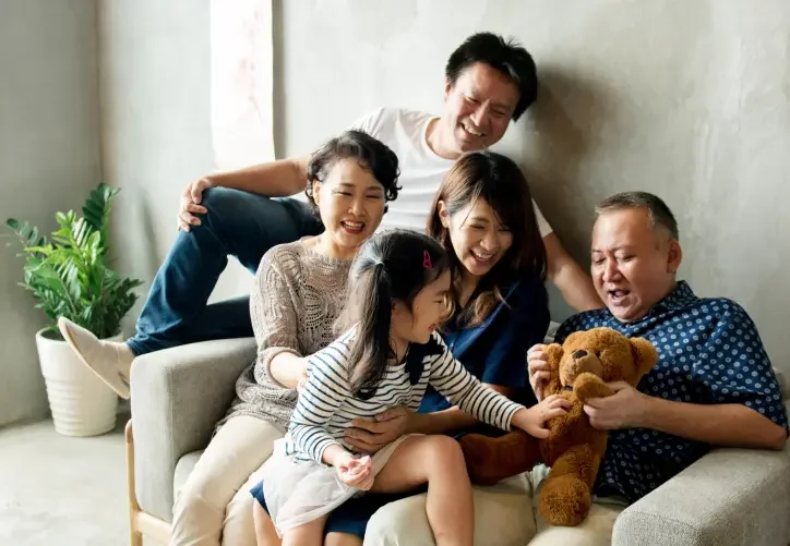 a family laugh together while playing a game.