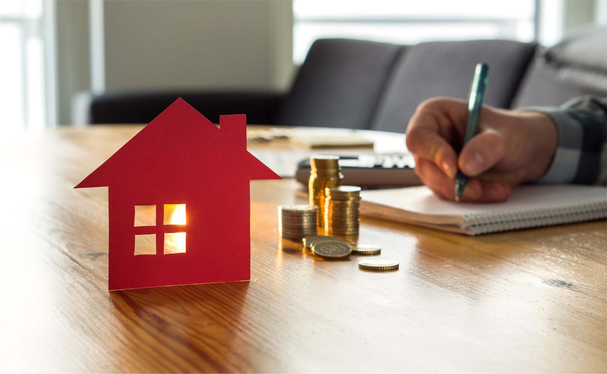 An image of a person calculating the rent with coins on the table.