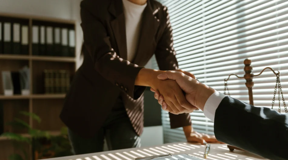 Two people shake hands in professional space