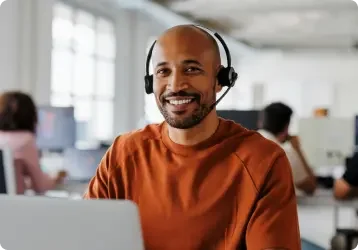 African American man answers calls on his headphones