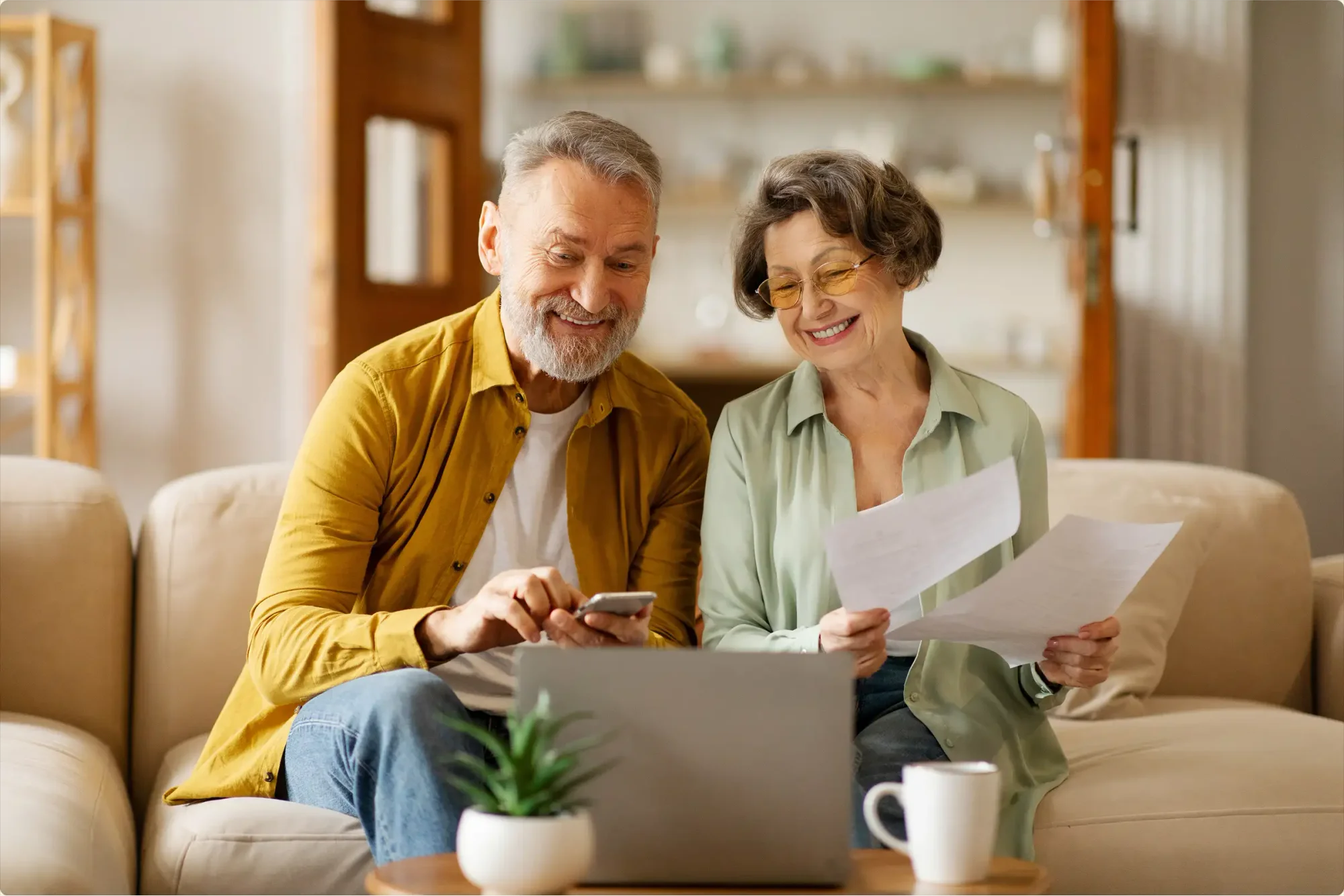 A husband checks whether electronic wills are legal in Florida from his phone, while his wife validates the physical copy of other estate plan-related documents.
