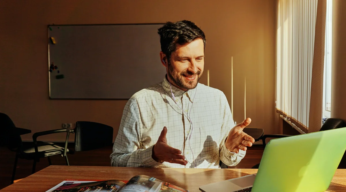 Man in checkered shirt on a video call