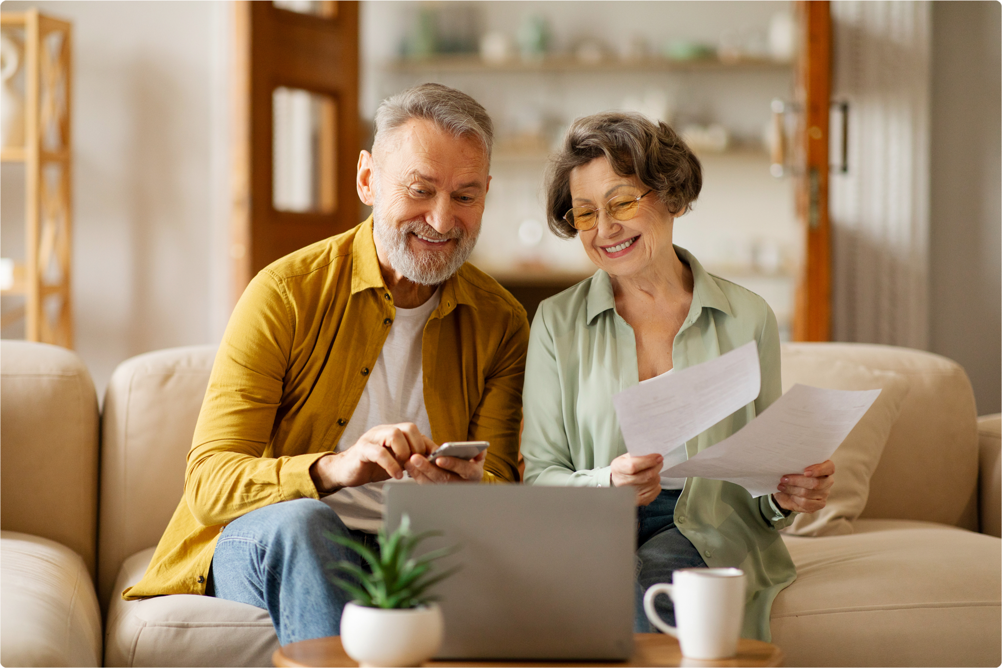 An aged husband checks whether electronic wills are legal in Florida from his phone, while his wife validates the physical copy of other estate plan-related documents.