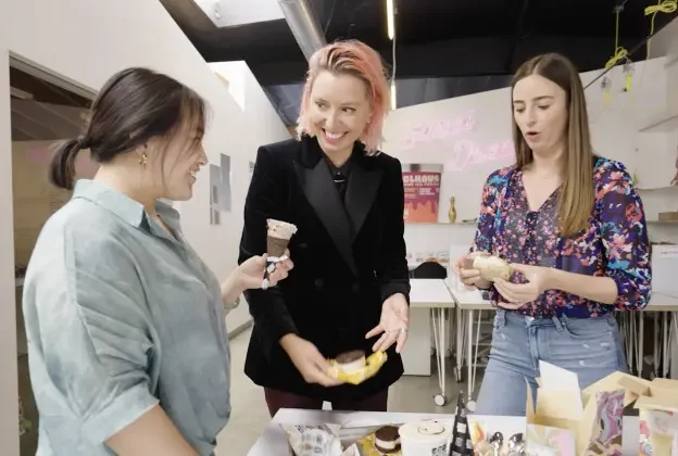 three woman speak and eat ice cream together