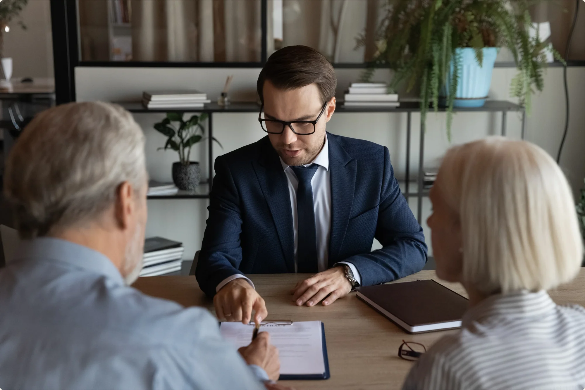 An estate planning attorney guides an elderly couple about the process of writing and creating a valid will in Florida. 