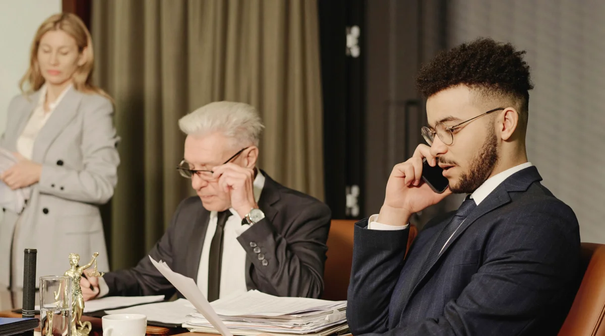 People in suits working at a conference table