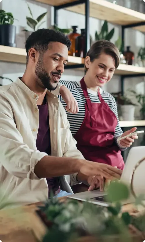 A married couple conducting research on a laptop on hiring a lawyer to draft a postnuptial agreement