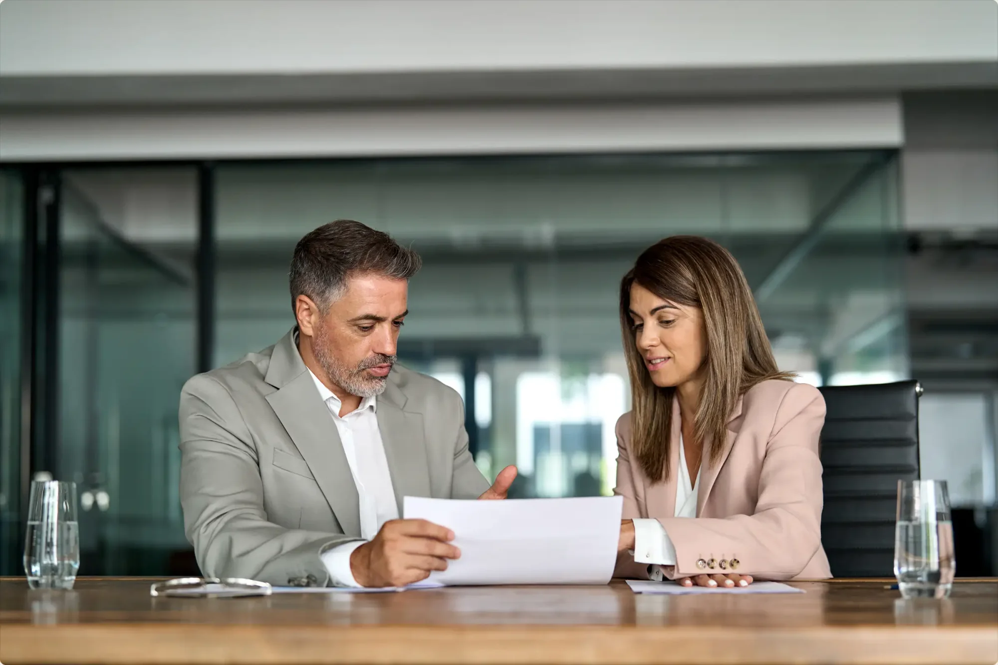Two business professionals are creating their estate planning documents, keeping their business continuation plans for the future in mind, after understanding the legal requirements they should consider while creating their respective wills in Florida.
