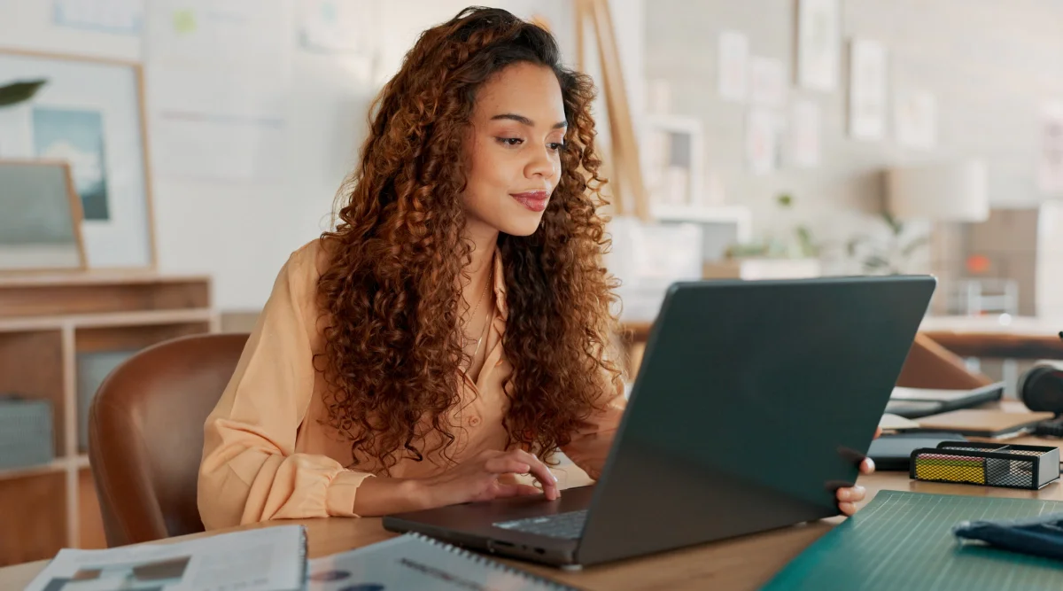 Woman working on a laptop in a creative space