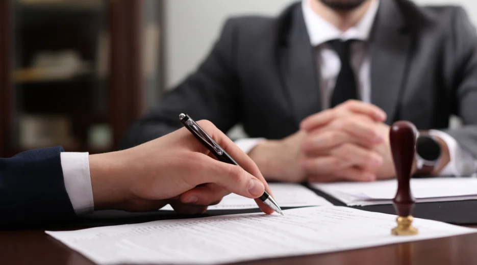 A man checks for any common mistakes in a will along with his colleague.