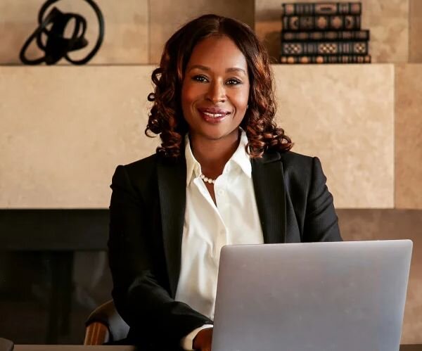 Female attorney smiling confidently in her office