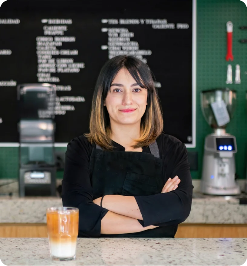 Satisfied woman in black shirt standing in coffee shop