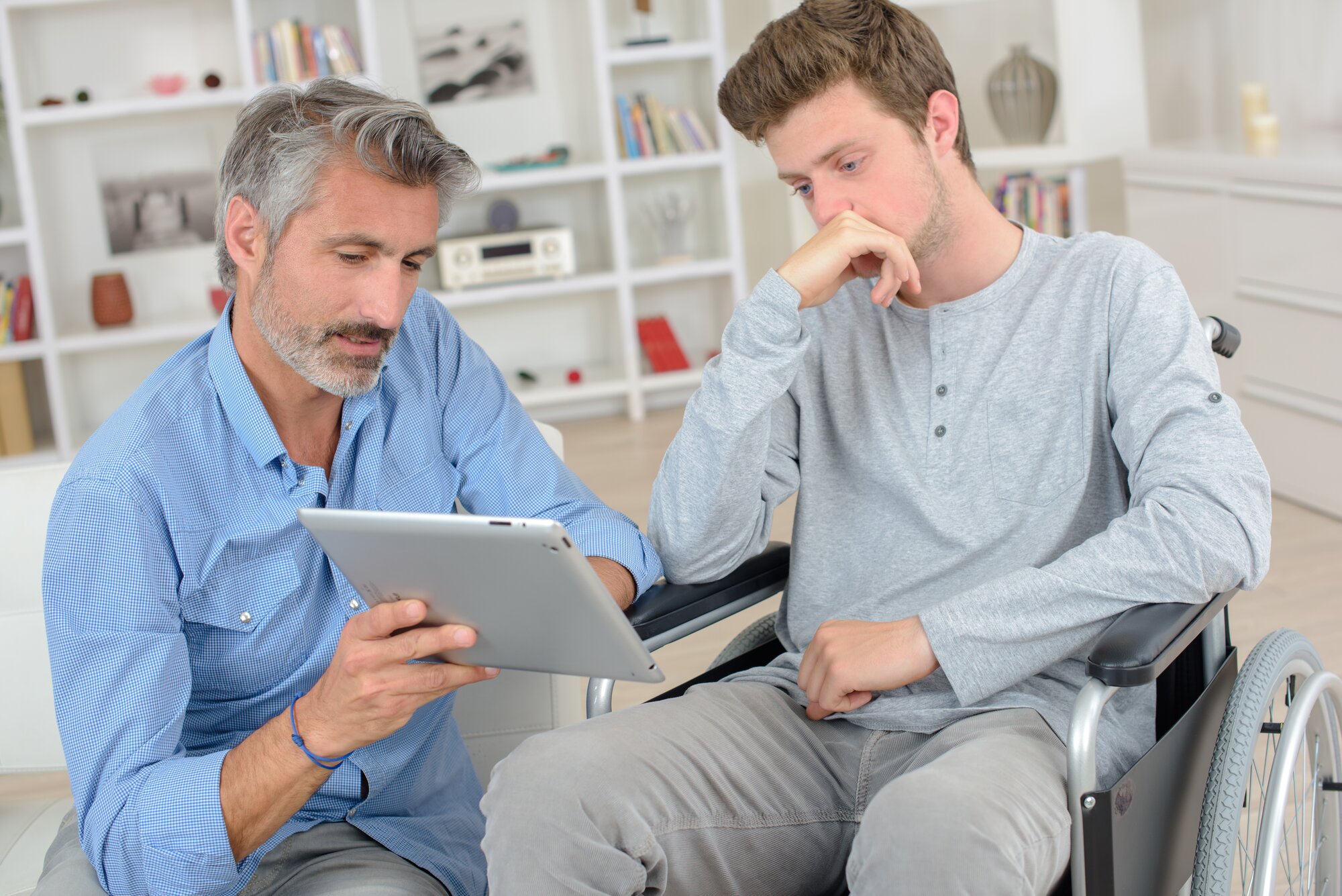 An image of a patient in a wheelchair looking at his estate planning documents before going for surgery.