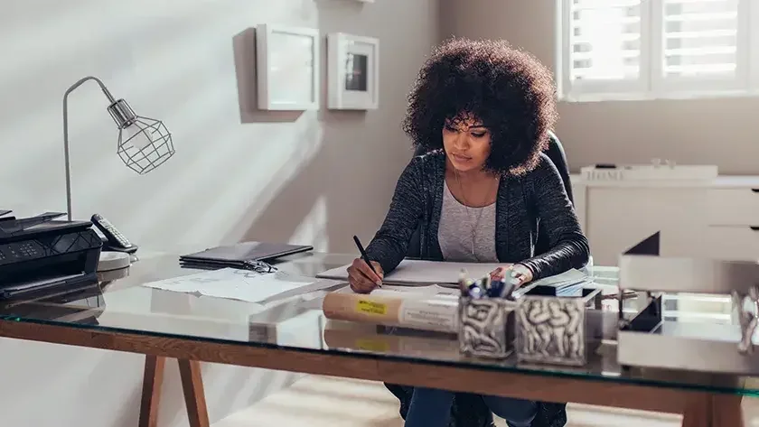 A Florida registered agent sits at her desk and examines documents she received for an LLC.