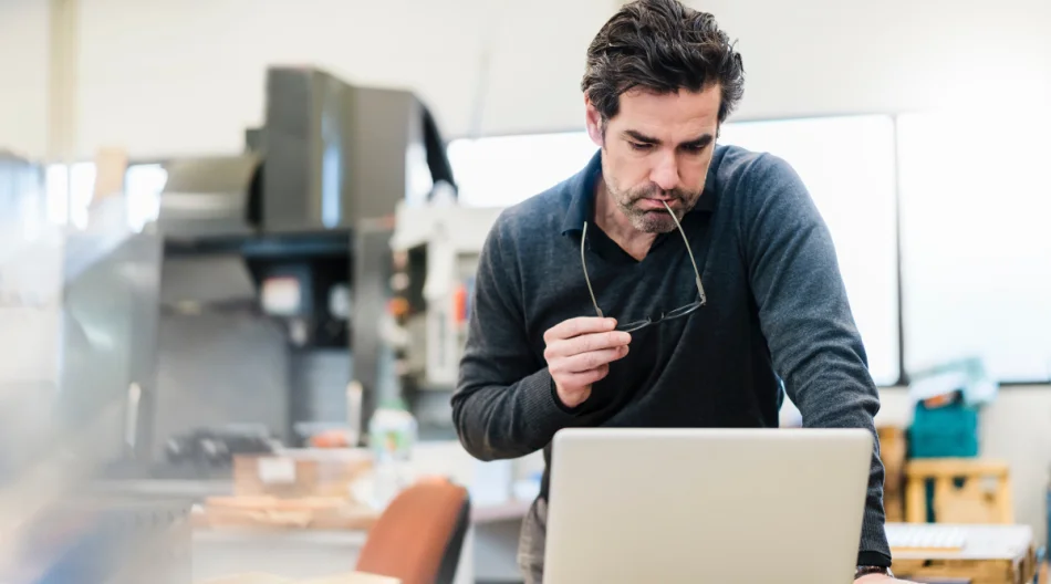 Man reviews documents in modern office