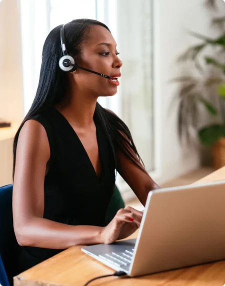An African American women works on her computer.  