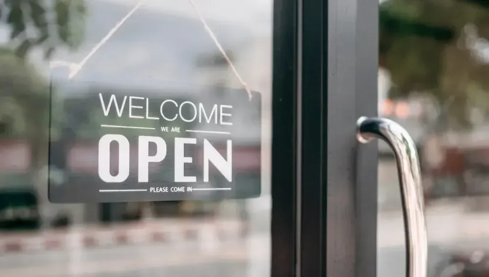 A shop displaying an open board meaning they are open for the day