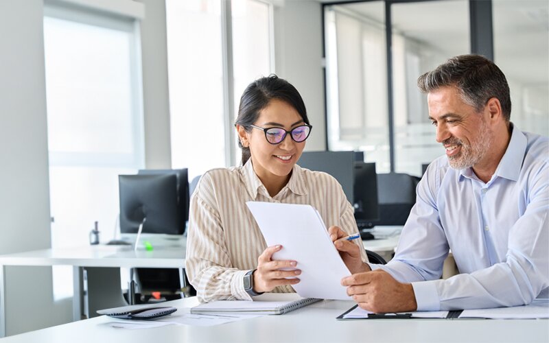 An image of 2 employees discussing the letter of recommendation.