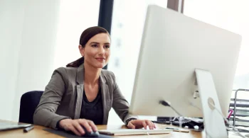 Woman using a desktop in a bright office