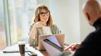 Woman in glasses having a discussion at a table