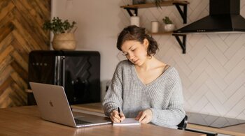 A woman comparing Ohio registered agent options at her desk.