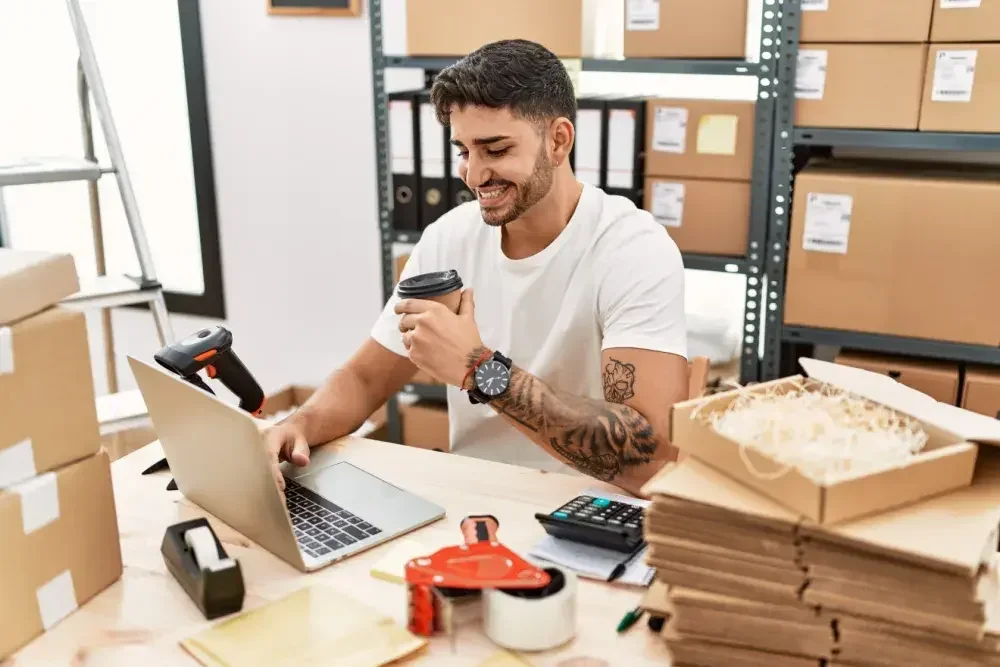 The owner of a shipping firm reads about tax extensions on his laptop as he enjoys his morning coffee.