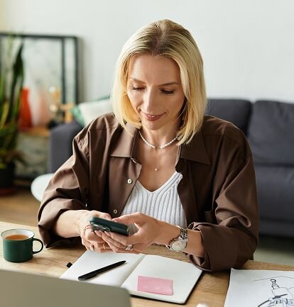 Smiling woman in blue shirt sitting at desk