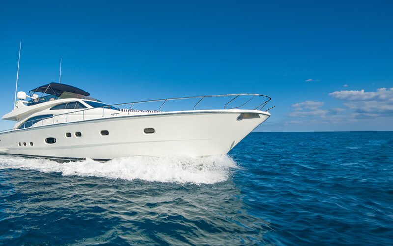 An image of a white boat sailing in the ocean. 