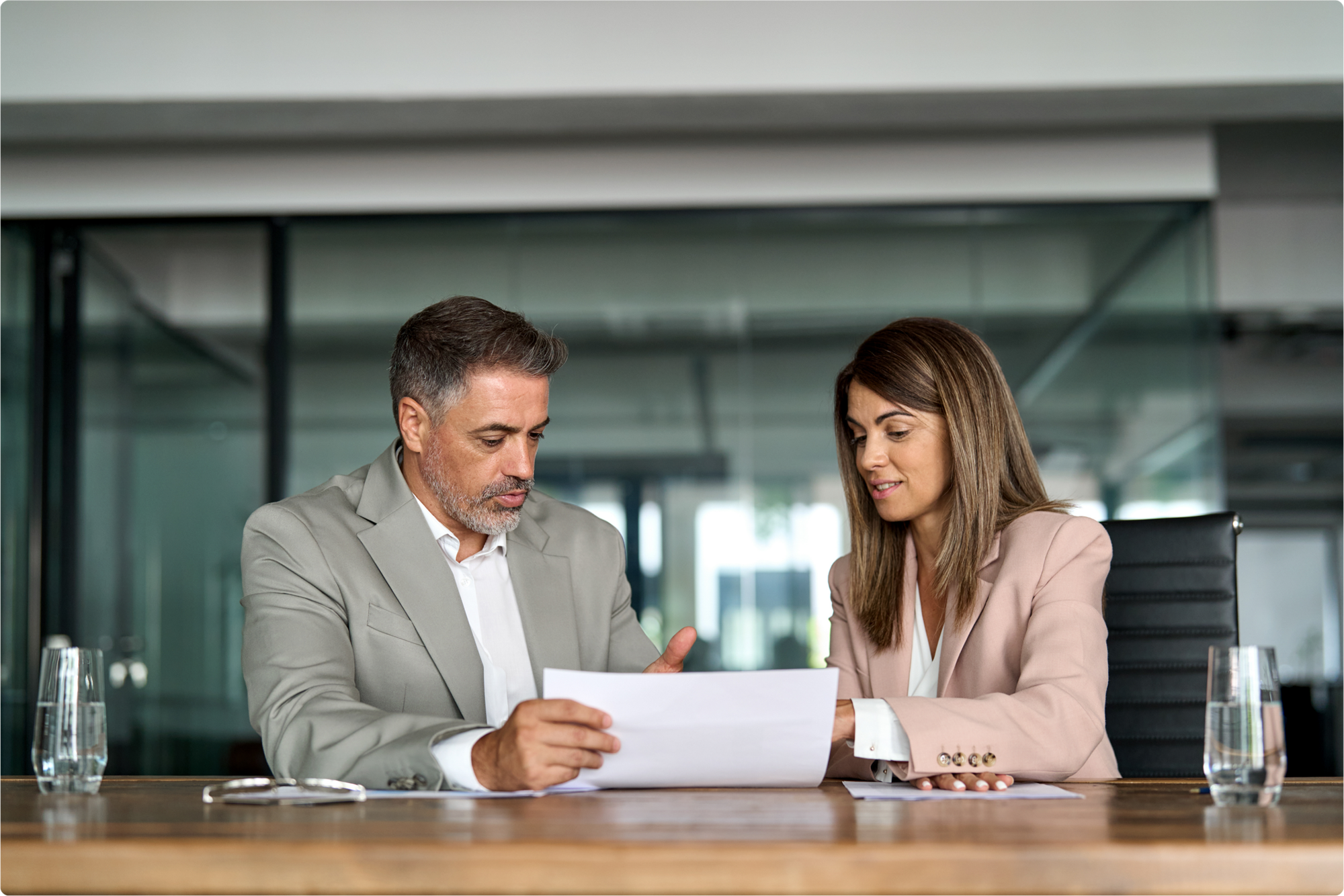 Two business professionals are creating their estate planning documents, keeping their business continuation plans for the future in mind, after understanding the legal requirements they should consider while creating their respective wills in Florida.