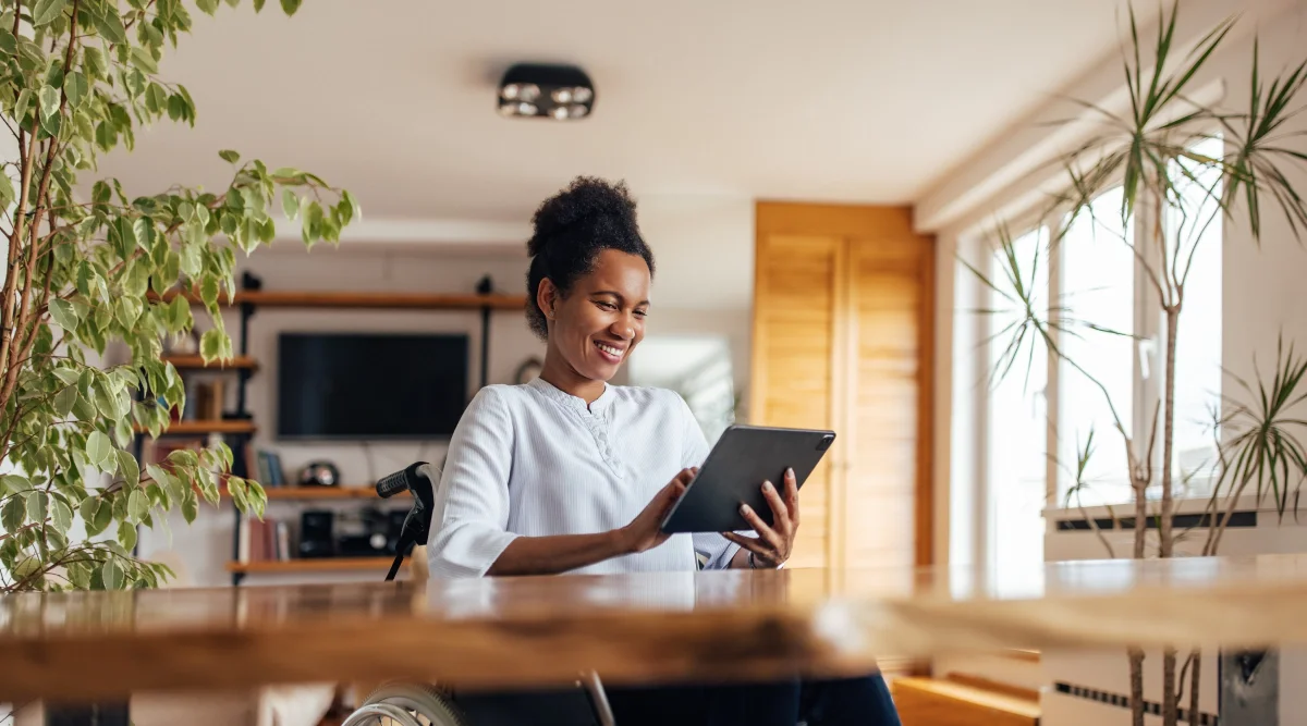 A woman reading on her tablet.