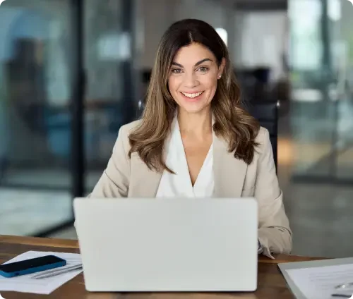 An attorney sitting at a desk and creating an independent contractor agreement on a laptop