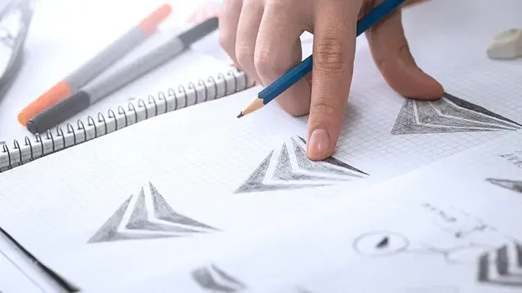 A designer reviews variations of a logo design in advance of a trademark application