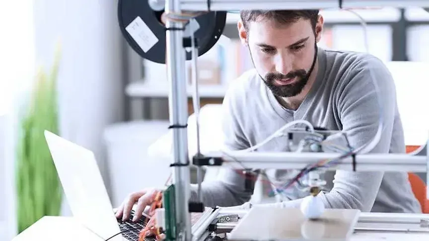 A small business owner works in his shop as he considers whether an S corp or a C corp would benefit him more.