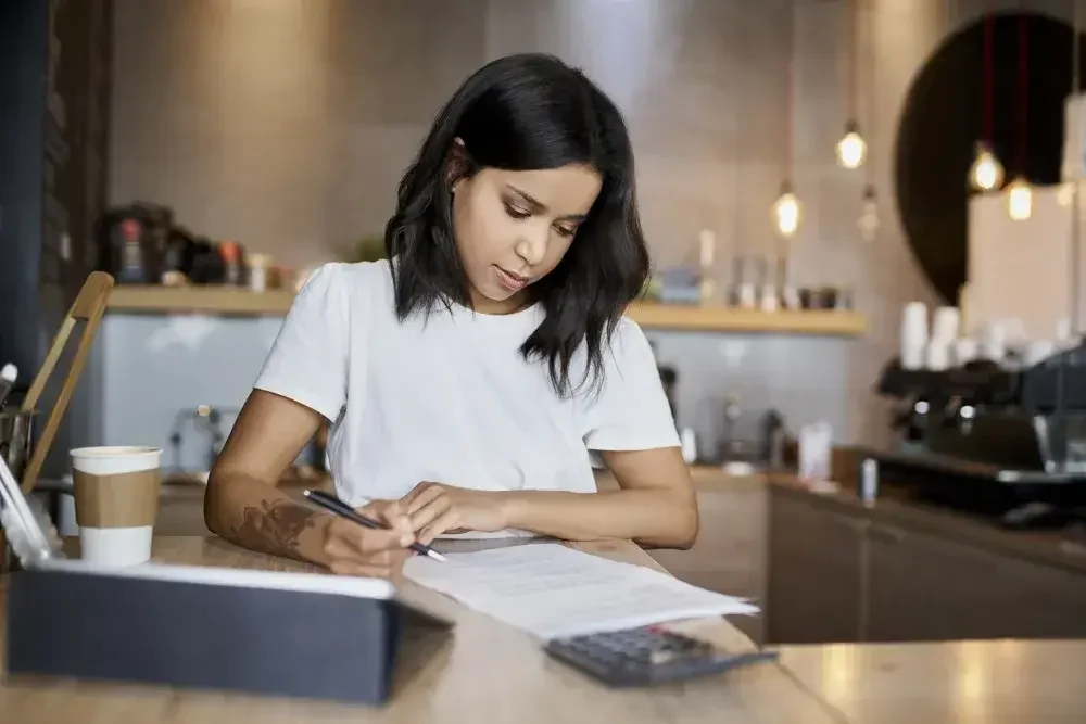 A woman acts as a witness by signing her name to a friend's last will and testament.