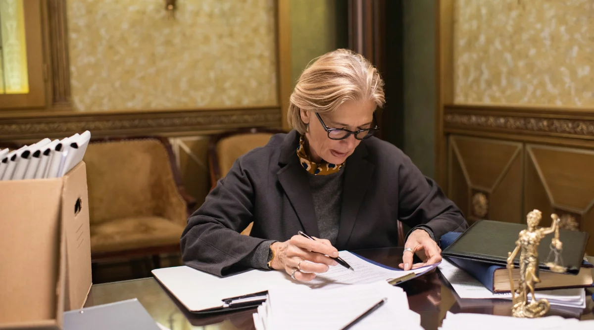 Woman in office reviewing documents at a desk